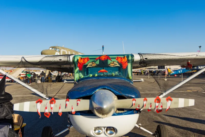 Halloween community fly-in at the airport with decorated aircraft and visitors