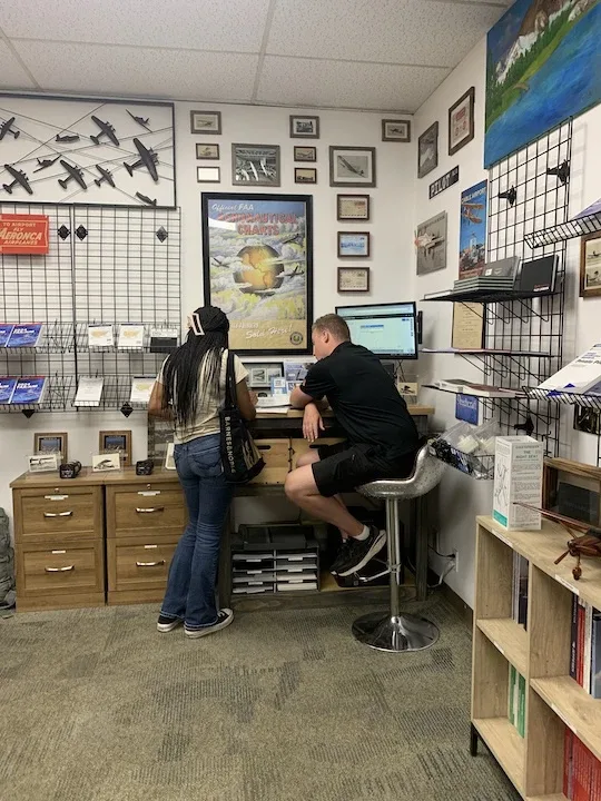 Pilot shop and dispatch area at Riverside Municipal Airport with FAA charts and reference materials