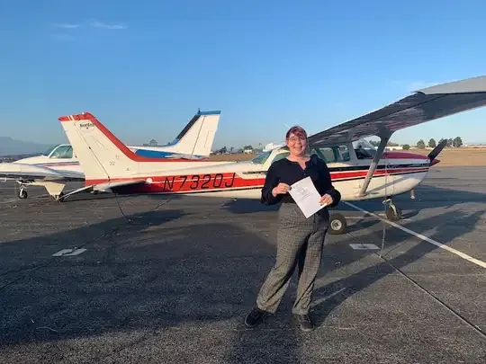 Student pilot celebrating after passing the Private Pilot checkride at Riverside Municipal Airport